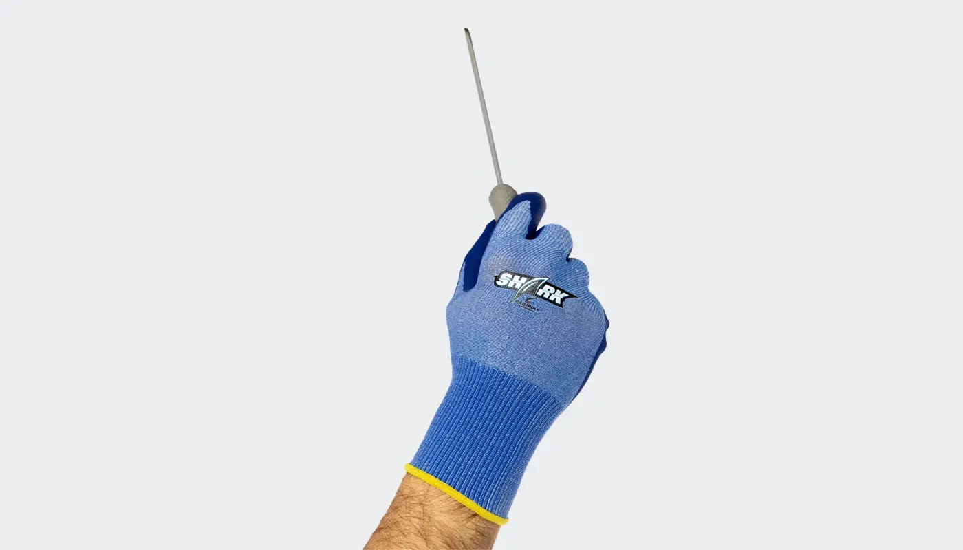 A hand in a Pad Glove cut-resistant glove with COOLMAX® fiber holds up a screwdriver